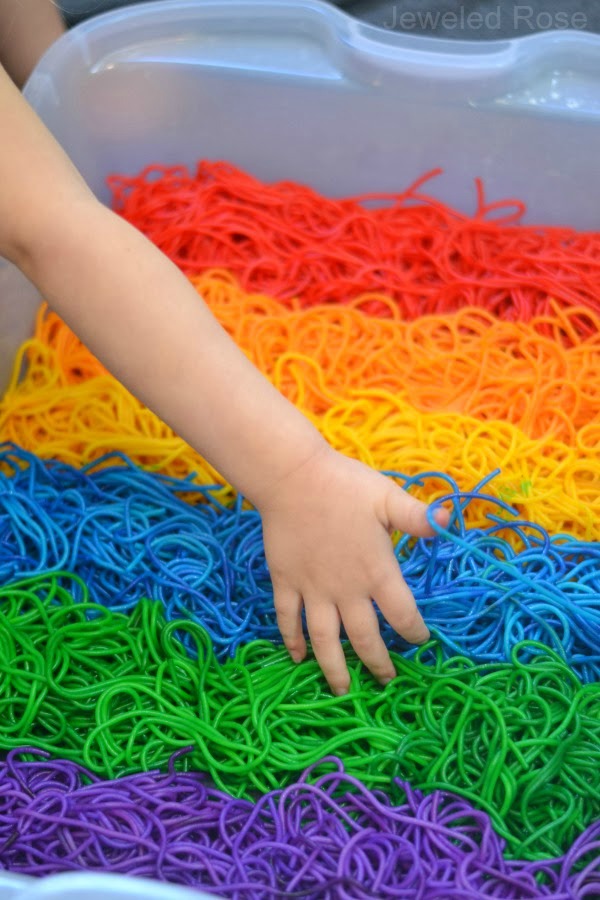 Dye noodles in every color to make rainbow spaghetti for kids. #rainbowspaghetti #howtodyepasta #sensoryactivitiestoddlers #sensoryplay #growingajeweledrose #activitiesforkids
