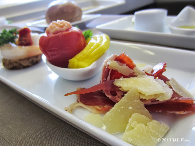 JAL First Class trip report on JL005: Amuse bouche - Iberico ham with parmesan cheese