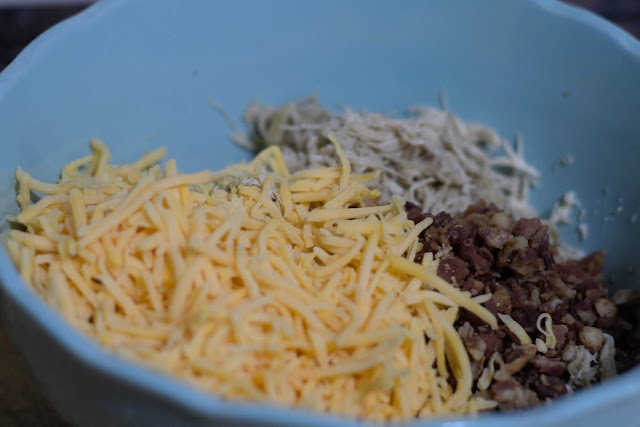 Cheese being added to the bowl. 