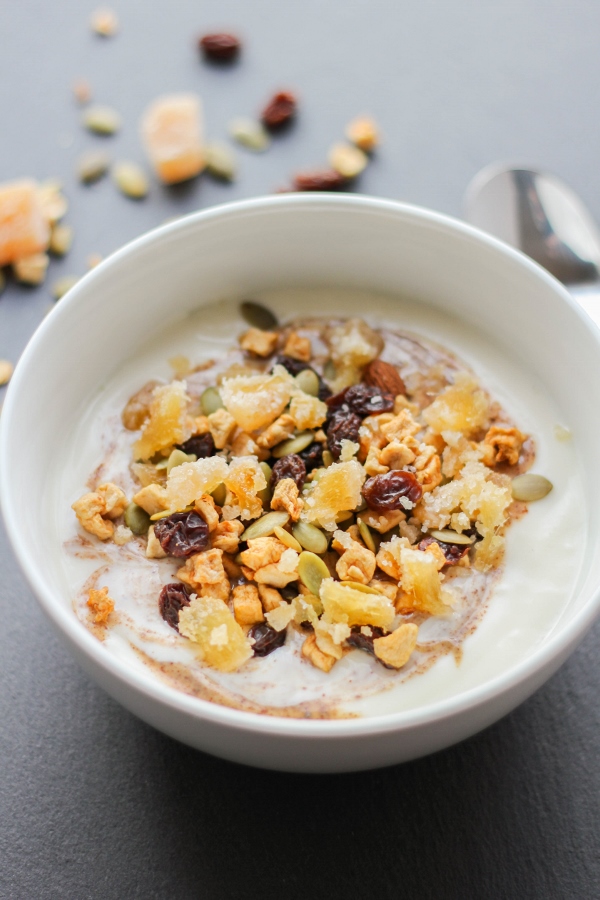 This protein packed delicious yogurt bowl starts with creamy vanilla grassfed yogurt and is topped with almond butter, harvest trail mix, and bites of sweet and spicy crystallized ginger. It's the best way to start your day!