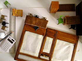 View of a modern dolls' house miniature cafe in progress, from the top.