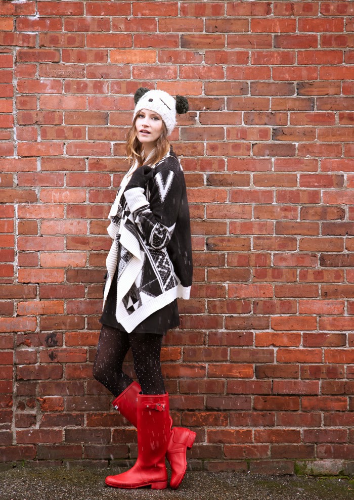 Vancouver fashion blogger, Alison Hutchinson, is wearing a Chicnova sweater, Love shift dress, red hunter boots and an Urban Outfitters teddy bear beanie 