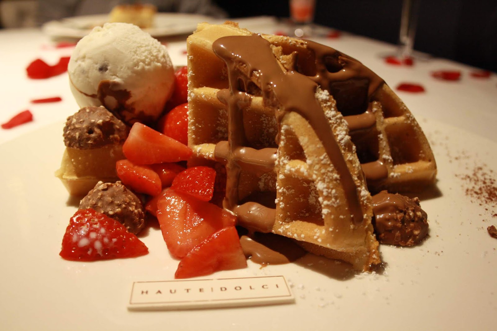 American style waffle with chocolate sauce, Ferrero ocher, strawberries and ice cream