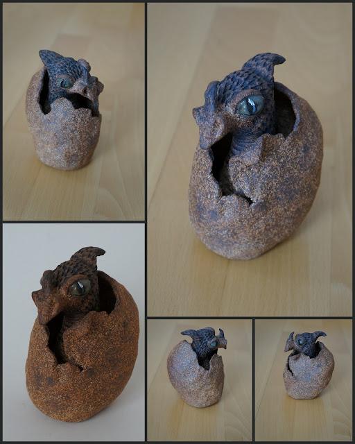 Ceramic / stoneware dragon hatching from an egg, by Lily L.