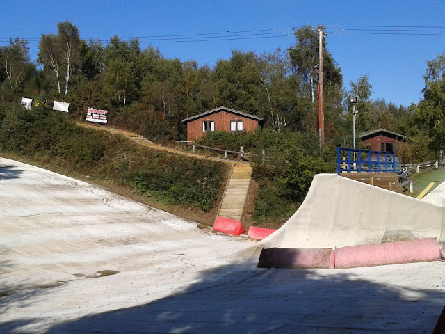 Ski slope Dry ski slope overlooked by a lodge on a hill