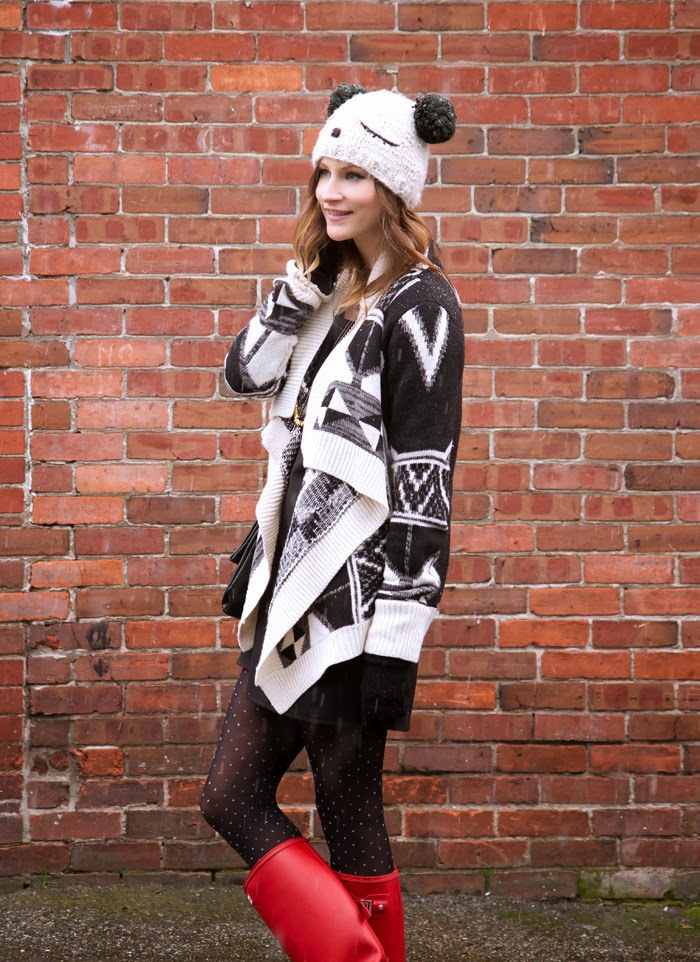 Vancouver fashion blogger, Alison Hutchinson, is wearing a Chicnova sweater, Love shift dress, red hunter boots and an Urban Outfitters teddy bear beanie 