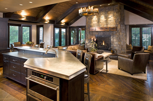 Stony Rustic Fireplace Mantels to Decorate Your Rustic Living Room Cozy Family Room with Rounded Chandelier and Stone Rustic Fireplace Mantels near Brown Sofas and Low Table