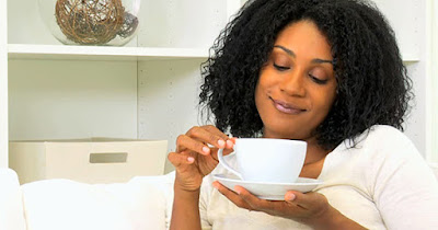 Black woman drinking coffee