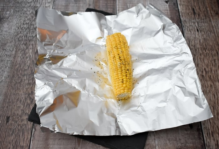 seasoned corn on the cob on foil