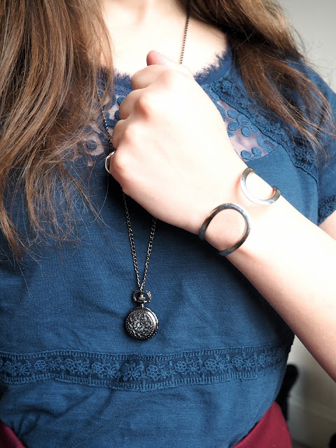 Just a Kid from Brooklyn | Captain America Marvel/ Disneybound outfit jewellery details of black pocket watch pendant necklace & silver bangle, with dark blue top