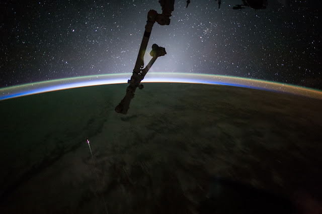 Earth and Dragon Spacecraft seen from the International Space Station