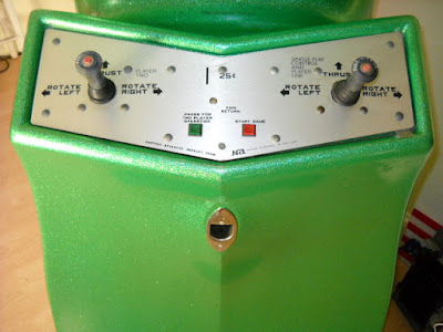 Computer Space panel 1972 Green with speckle-fleck glitter cabinet and brushed stainless steel shallow-V control panel with two joysticks, two buttons, coin slot and instructions.