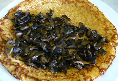 Pancakes stuffed with champignons