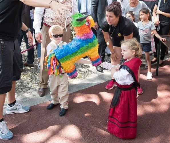 Princess Charlene wore AKRIS silk crepe striped dress and Stuart Weitzman Sandal. Princess Caroline, Beatrice Borromeo, Princess Gabriella