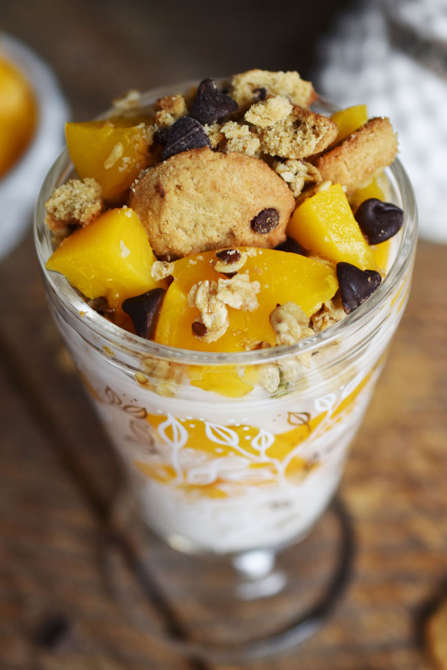 This dessert parfait features a base of cultured coconut (aka coconut yogurt) mixed with semi-sweet chocolate chips and a bit of maple syrup for sweetness. Layering this yogurt mixture with naturally sweet and healthy California cling peaches and crunchy granola makes for a satisfying taste sensation that will have you forgetting about rich, fatty desserts. #vegan #glutenfree #healthy