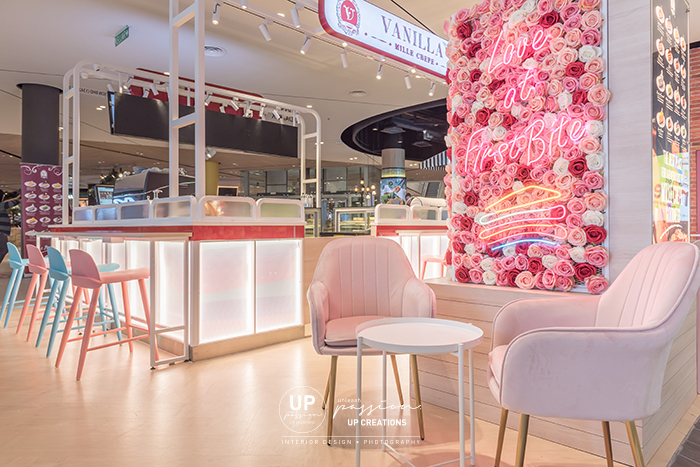 Central i city vanilla mille crepe kiosk highlighted area with floral, led neon signage and pastel pink color armchair