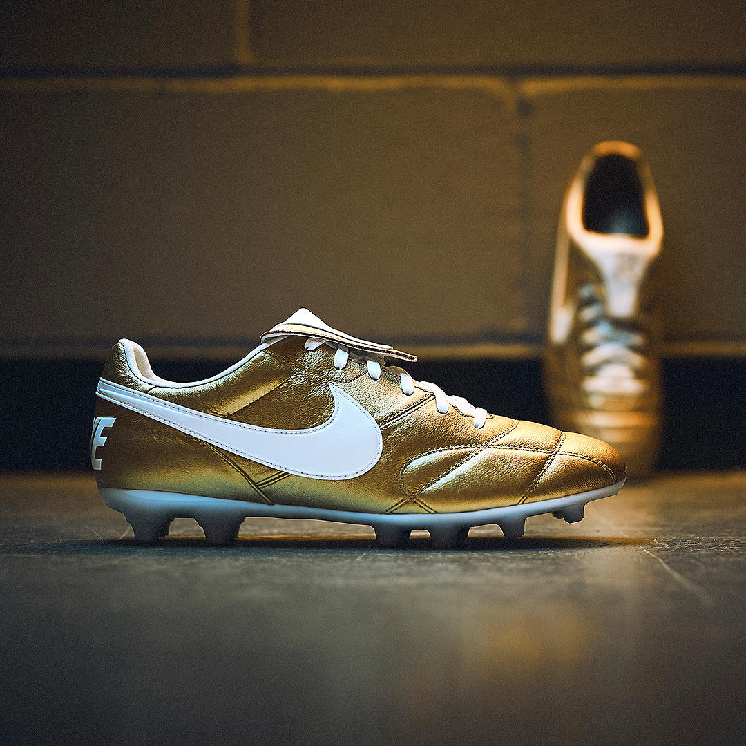 nike gold and white boots