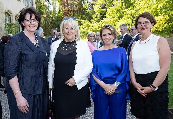 Duke Henri, Maria Teresa, Prince Guillaume and Princess Stephanie at a reception. Maria Teresa wore blue dress, Stephanie wore Prada floral dress