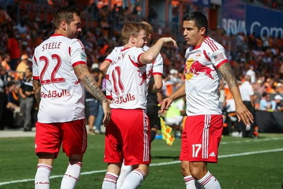 Tim Cahill celebrates with Red Bulls teammates after scoring a goal against Houston Dynamo