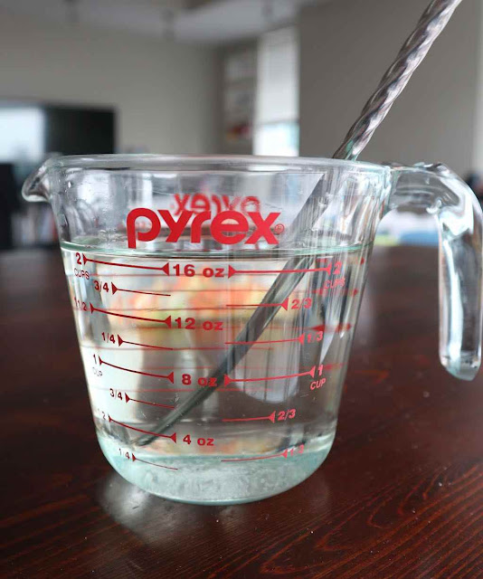 simple syrup in a clear pyrex jar