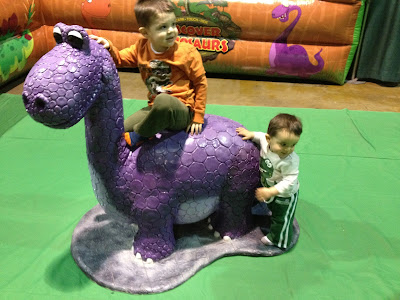 My kids riding the purple dinosaur.