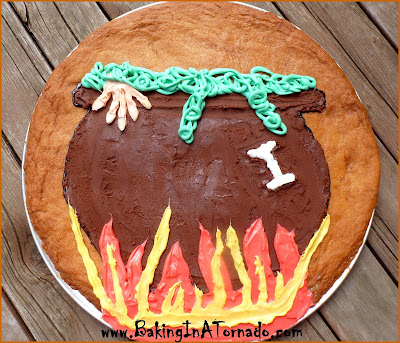 Witch's Caldron Giant Cookie: A giant cookie decorated with chocolate and white frosting for delicious Halloween fun | Recipe developed by www.BakingInATornado.com | #recipe #Halloween