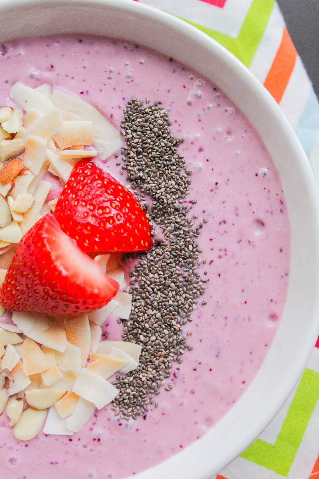 Mixed Berry Smoothie Bowl with Toasted Coconut Chips and Almonds
