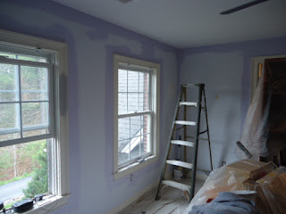 Prepping  and cutting in the bedroom for painting.