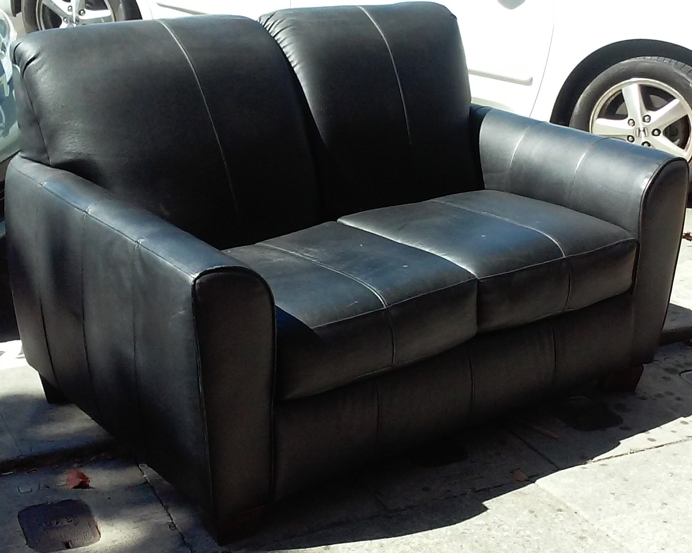 UHURU FURNITURE & COLLECTIBLES SOLD **REDUCED** Black Vinyl Loveseat