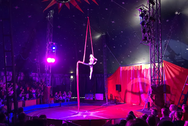 Aerial performer at Lawson's circus Van Hage A young girl balancing while in the air with a thick ribbon like rope