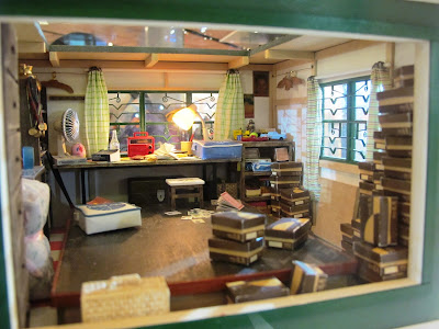 Interior of the upstairs office of a miniature model of a Hong Kong shoe shop from the 1960s.