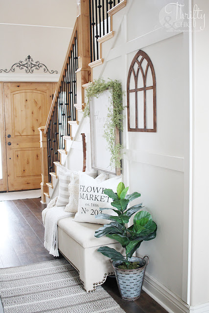 Spring entry way decor. How to decorate your stairs. Hallway decorating ideas. Spring decor and decorating ideas. Farmhouse spring decor. Easy spring decor. Entry way storage. Two story entry way with stairs.