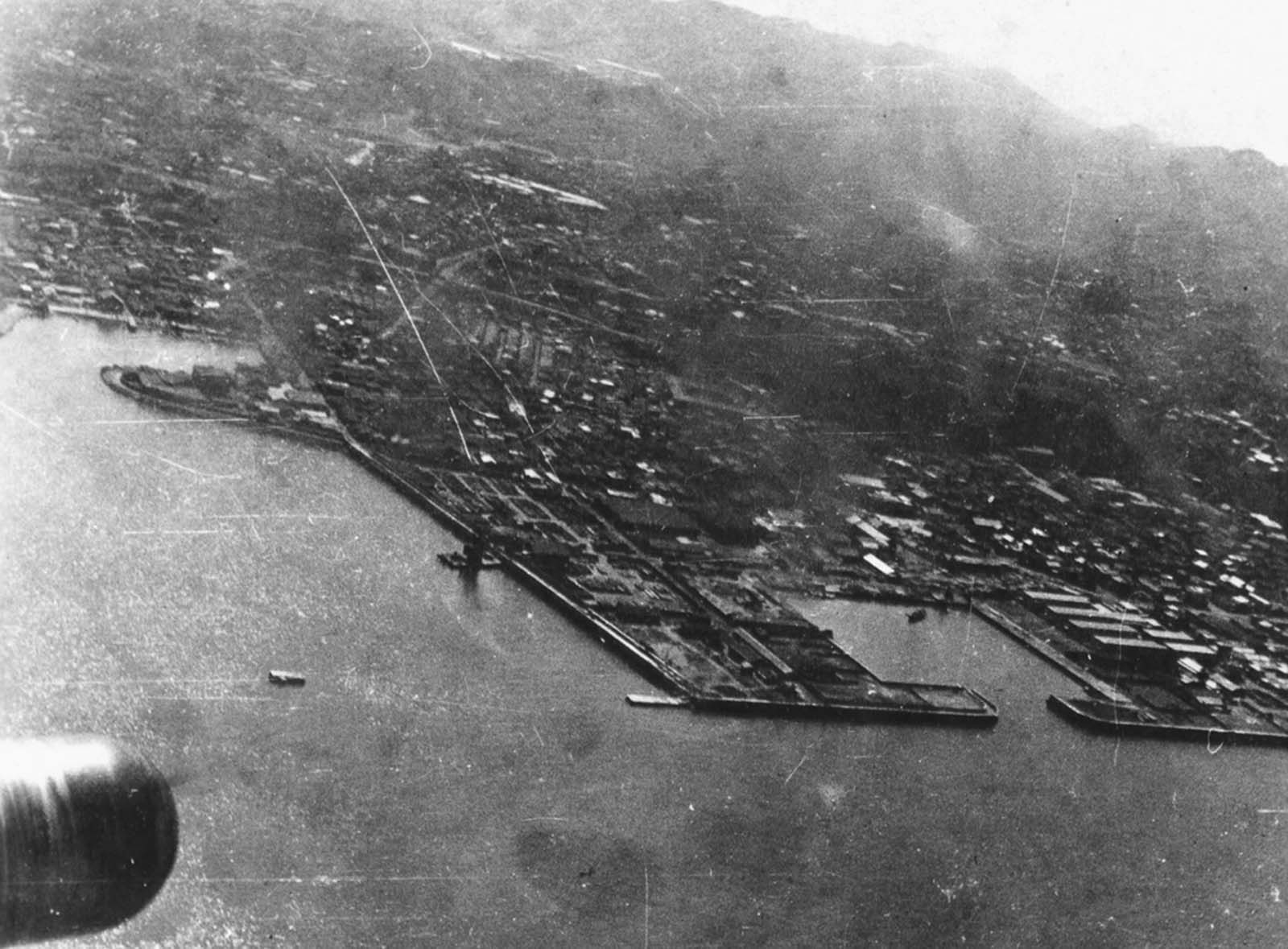 Above Tokyo, smoke rises from strikes on the Japanese mainland as the bombs dropped by Doolittle's raiders hit their targets on April 18, 1942. Unable to land the huge aircraft back on the USS Hornet, and running low on fuel, the bombers continued westward attempting to land in a friendly area in China.