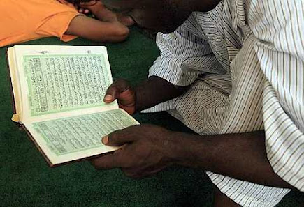 A Muslim man reads the Koran