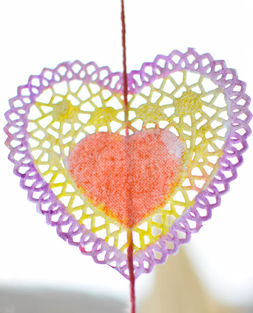 Valentine Suncatchers- Beautiful watercolor heart process art painting project for preschool, kindergarten, or elementary kids. Brighten up a dreary winter day with this pretty, colorful craft!