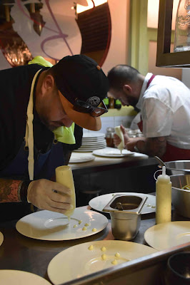 two chefs plating dinners in restaurant kitchen