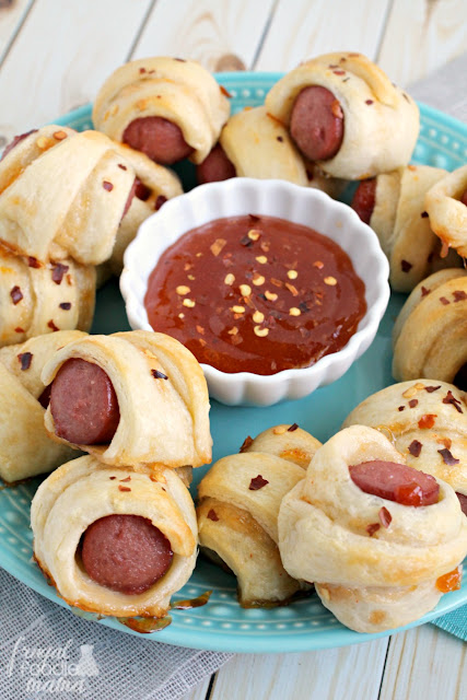 A childhood favorite gets a sweet & spicy makeover perfect for the adults in these Apricot Sriracha Pigs in a Blanket.