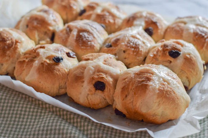 Traditional homemade Hot Cross Buns. Easy recipe using raisins and cinnamon, nutmeg, and ginger. Perfect for Easter