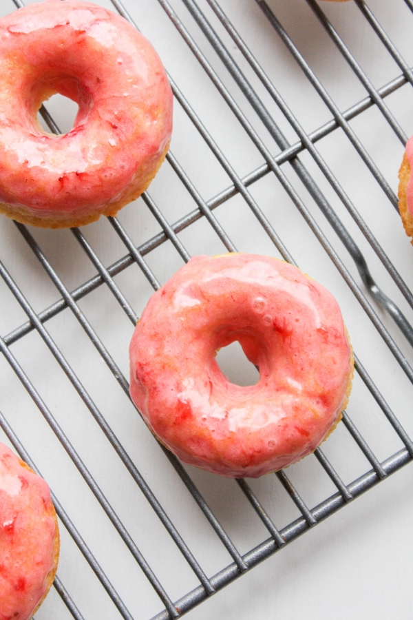 These cardamom donuts are light and fluffy, baked not fried, and topped with a simple and sweet strawberry frosting. They are perfect for spring!