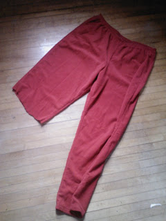 Red pants with one leg cut off at the knee.