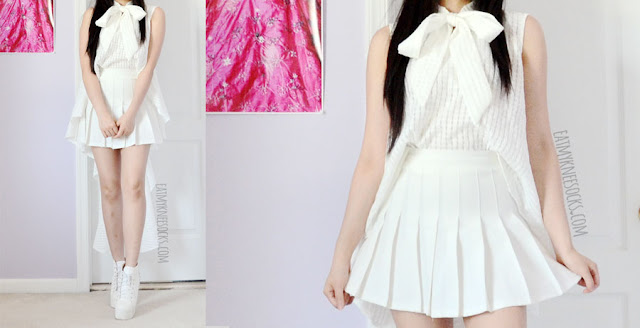 Twist X Turn Fashion Review: Monochrome Minimalist Tops Details on the white dramatic ruffle high-low sleeveless gridded self-tie blouse from Twist X Turn, modeled with a pleated white tennis skirt from American Apparel for an all-white monochromatic look.