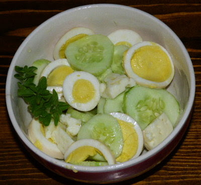 Homegrown salad of cucumber, hard-boiled egg, and goat feta cheese.