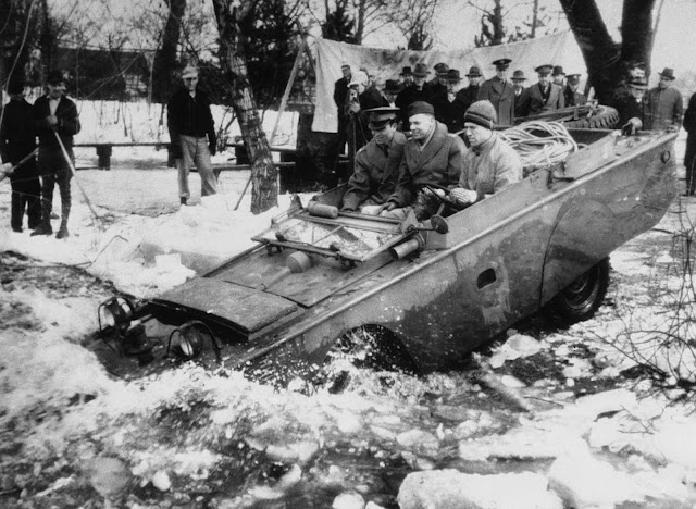 One of the newly-built quarter-ton four-wheel amphibian jeeps, produced for U.S. fighting forces, leaves solid ground for a test-run in an ice-clogged stream in the Detroit area on March 23, 1943.