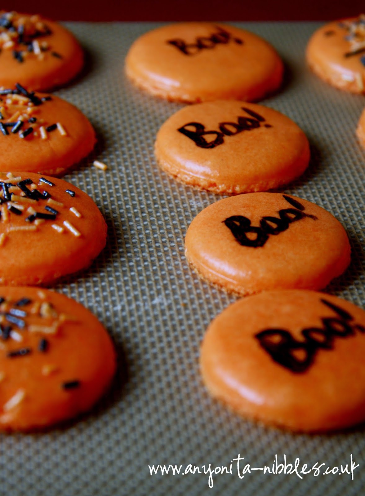 Halloween macarons with the word boo written on them from Anyonita Nibbles