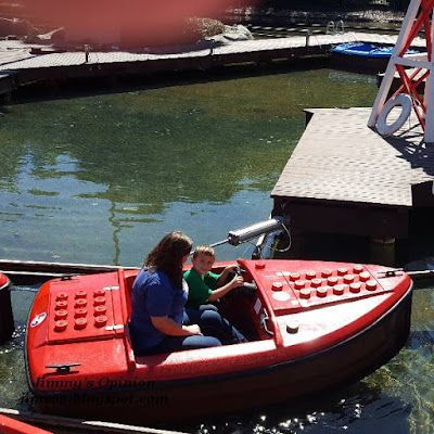 Benjamin taking his mom for a lego boat ride Our grandson Benjamin driving a red boat taking his mom for a ride at Legoland.