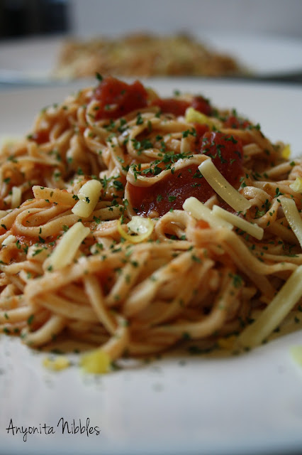 Two plates of homemade linguine with zesty tomato sauce