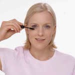 a woman applying eye make-up
