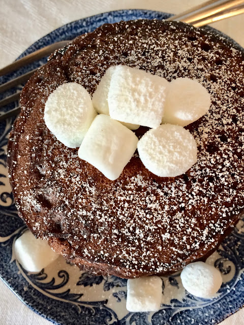 Top view of finished hot chocolate pancakes topped with powdered sugar.