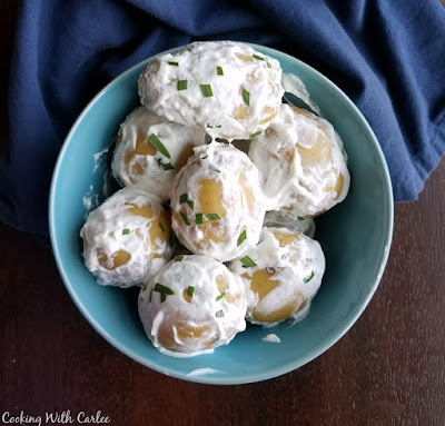 A perfectly simple way to serve small, tender, new potatoes! The recipe may be simple, but the flavor is delicious! small bowl of little sour cream coated potatoes