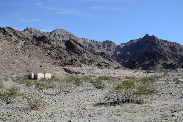 standing walls near a pouring of odd sand